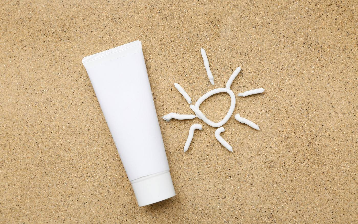 Sunscreen flat lay representing summer laser care